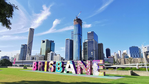 Brisbane sign with CBD skyline behind it